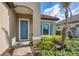 Blue front door entryway with brick walkway and landscaping at 26812 Pavin Dr, Englewood, FL 34223