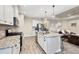 Modern kitchen with granite countertops, stainless steel appliances, and an island at 26812 Pavin Dr, Englewood, FL 34223