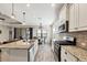 Bright kitchen, granite island, stainless steel appliances, and tile flooring at 26812 Pavin Dr, Englewood, FL 34223