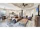Living room with brown leather sofas and large TV, hardwood floors at 26812 Pavin Dr, Englewood, FL 34223