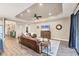 Spacious living room with hardwood floors, brown leather sofas, and large TV at 26812 Pavin Dr, Englewood, FL 34223
