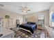 Spacious main bedroom with a king-size bed and ceiling fan at 26812 Pavin Dr, Englewood, FL 34223
