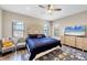 Main bedroom with king bed, ceiling fan, and large TV at 26812 Pavin Dr, Englewood, FL 34223