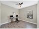 Home office featuring two computer setups, a comfortable kneeling chair, and natural light at 26812 Pavin Dr, Englewood, FL 34223
