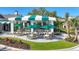 Community patio with green striped awning and seating area at 26812 Pavin Dr, Englewood, FL 34223