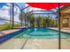 Inviting screened-in pool with a red umbrella and plenty of lounging space at 26812 Pavin Dr, Englewood, FL 34223