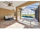 Covered patio with seating area adjacent to the pool at 26812 Pavin Dr, Englewood, FL 34223