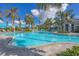 Expansive resort-style pool with lounge chairs and palm trees at 26812 Pavin Dr, Englewood, FL 34223
