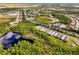 Aerial view of community with houses near a lake and preserve at 2759 Lavandula Ct, North Port, FL 34289