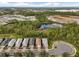 Aerial view of community with houses, lake, and lush vegetation at 2759 Lavandula Ct, North Port, FL 34289