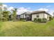 Large backyard with grassy area and screened patio at 2759 Lavandula Ct, North Port, FL 34289