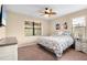 Spacious bedroom with a ceiling fan and large windows at 2759 Lavandula Ct, North Port, FL 34289