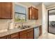 Kitchen boasts granite countertops, double sink, and modern dishwasher at 2759 Lavandula Ct, North Port, FL 34289