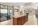 Open kitchen with granite island and access to backyard patio at 2759 Lavandula Ct, North Port, FL 34289