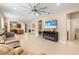 Open living room with tile floors, large TV and kitchen view at 2759 Lavandula Ct, North Port, FL 34289