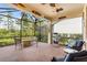 Screened patio with fire pit and outdoor seating area at 2759 Lavandula Ct, North Port, FL 34289
