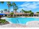 Community pool with a large deck and lounge chairs at 2759 Lavandula Ct, North Port, FL 34289