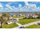 Aerial view of property near a lake and new homes at 3265 Smith St, Englewood, FL 34224