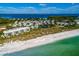 Aerial view of community with beach and lagoon at 5850 Gasparilla Rd # M7, Boca Grande, FL 33921