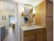 Stylish bathroom with light wood cabinets, a quartz countertop, and a gold mirror at 5850 Gasparilla Rd # M7, Boca Grande, FL 33921