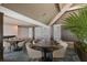 Elegant dining area with modern tables and neutral-toned chairs at 5850 Gasparilla Rd # M7, Boca Grande, FL 33921