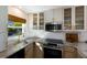 Modern kitchen with stainless steel appliances and marble countertops at 5850 Gasparilla Rd # M7, Boca Grande, FL 33921