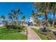Brick pathway leads to a beautiful waterfront home with lush landscaping at 5850 Gasparilla Rd # M7, Boca Grande, FL 33921