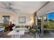 Bright living room with comfy seating, large windows, and access to balcony at 5850 Gasparilla Rd # M7, Boca Grande, FL 33921