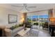 Living room with water view and comfortable seating at 5850 Gasparilla Rd # M7, Boca Grande, FL 33921