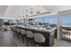 Long bar with ocean views and modern pendant lights at 5850 Gasparilla Rd # M7, Boca Grande, FL 33921