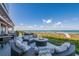Relaxing oceanfront patio with fire pit and seating at 5850 Gasparilla Rd # M7, Boca Grande, FL 33921