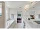 Main bathroom with double vanity, soaking tub, and walk-in shower at 7297 Jennifer Dr, Port Charlotte, FL 33981