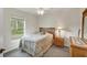 Cozy bedroom with wood furniture and large window at 7297 Jennifer Dr, Port Charlotte, FL 33981