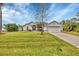 House exterior featuring a spacious lawn and driveway at 7297 Jennifer Dr, Port Charlotte, FL 33981