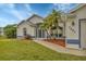 Front view of a single-story house with a landscaped yard and palm trees at 7297 Jennifer Dr, Port Charlotte, FL 33981