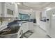 White kitchen with ample counter space, a breakfast nook, and stainless steel appliances at 7297 Jennifer Dr, Port Charlotte, FL 33981