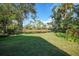 Grass yard with pond view, offering a tranquil outdoor space at 8527 Creekview Ln, Englewood, FL 34224