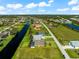 Aerial view of a canal-front community with single-Gathering homes at 912 Boundary Blvd, Rotonda West, FL 33947