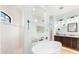 Bathroom boasts a large soaking tub, shower, and double vanity at 912 Boundary Blvd, Rotonda West, FL 33947