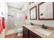 Bathroom with granite double vanity and walk-in shower at 912 Boundary Blvd, Rotonda West, FL 33947