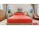 Main bedroom with coral bedding, wicker furniture, and natural light at 912 Boundary Blvd, Rotonda West, FL 33947