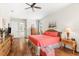 Spacious bedroom with coral bedding, wicker furniture, and hardwood floors at 912 Boundary Blvd, Rotonda West, FL 33947