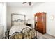 Bedroom with an antique wardrobe and metal bed frame at 912 Boundary Blvd, Rotonda West, FL 33947