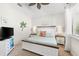 Main bedroom with white platform bed and ceiling fan at 912 Boundary Blvd, Rotonda West, FL 33947