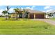 Beautiful house with a three-car garage and manicured lawn at 912 Boundary Blvd, Rotonda West, FL 33947