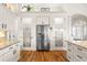 Bright kitchen boasts granite counters, stainless steel fridge, and pantry at 912 Boundary Blvd, Rotonda West, FL 33947