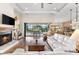 Spacious living room with a fireplace, hardwood floors, and access to a pool area at 912 Boundary Blvd, Rotonda West, FL 33947
