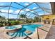 Resort-style pool and spa with covered patio at 912 Boundary Blvd, Rotonda West, FL 33947