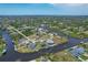 Aerial view showcasing home's canal-front location at 9222 Melody Cir, Port Charlotte, FL 33981