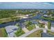 Bird's-eye view of a canal-front home with lush landscaping at 9222 Melody Cir, Port Charlotte, FL 33981